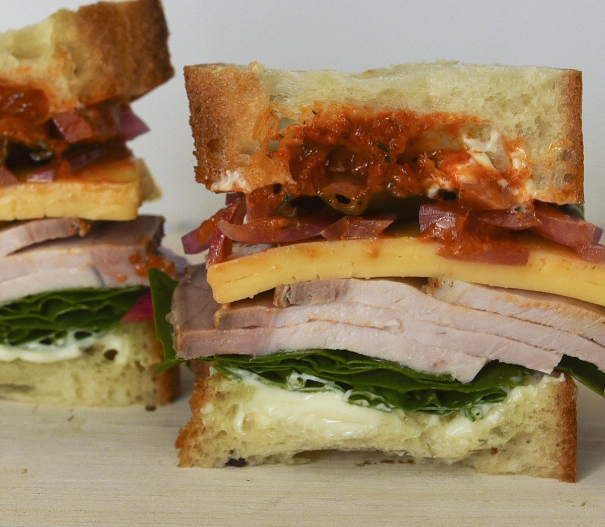 Roasted Pork Loin Sandwich with Smoked Gouda and Harissa Sauce